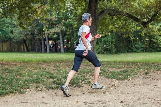 Senior woman runs at the park