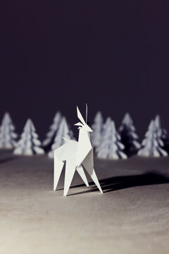 Origami Reindeer by night with origami trees