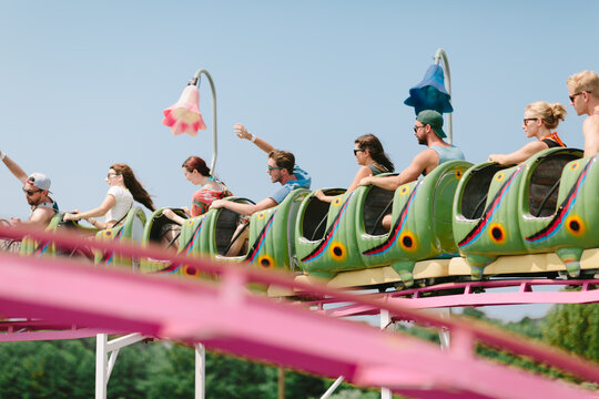A group of youthful friends enjoy a roller coaster ride