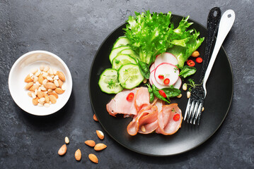 Breakfast, snack, ketogenic food. Sausage, salami, egg, cucumber, lettuce, delicious plate for a snack, lunch. View from above.