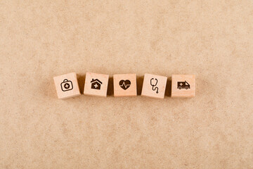 Medical check up concept with wooden blocks with medical icons on cardboard background flat lay....