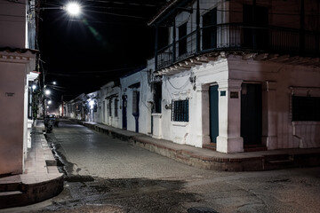 View to typical street with one story buildings at night in light of lanterns, Santa Cruz de Mompox, Colombia, World Heritage