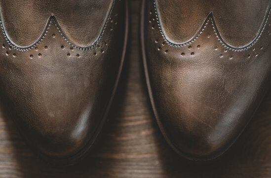 Leather shoes on the wooden floorin closeup