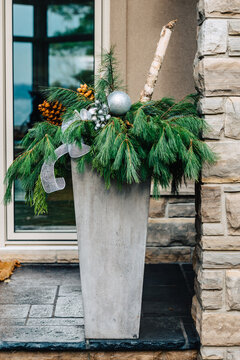 Christmas Themed Planter On A Front Porch