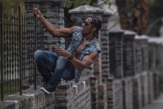 black boy hanging on the fence