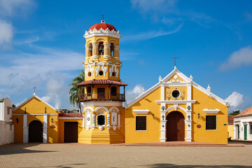 View to beautiful historic Church Santa Barbara (Iglesia de Santa Barbara)  and plaza Santa Cruz de Mompox in sunlight and blue sky, World Heritage