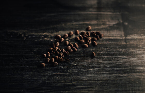 Coffee beans laying on a beautiful wooden table