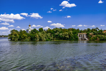Monastyrskyi Island with the St. Nicholas church and an artificial Roaring Threshold Waterfall in...
