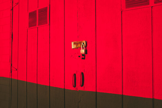Padlock on brightly colored building door