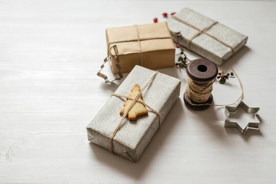 Christmas presents with pine tree shaped cookie on the white table