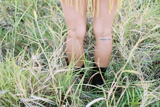 tattoo on pretty girl's legs of hawaii coordinates