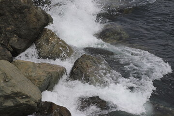 Waves from the Sea Crashing over Rocks on the Coast