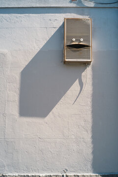 Happy face bent into aircon vent on the wall
