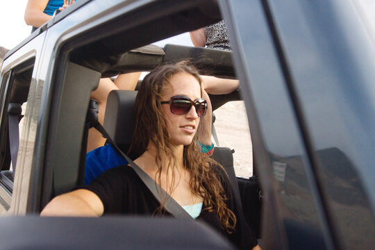 Woman passenger in vehicle on summer day