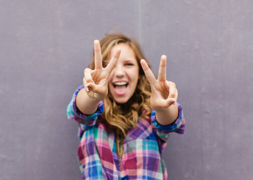 Teen girl having fun with peace signs