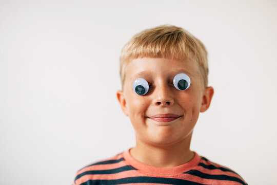 boy wearing googly eyes