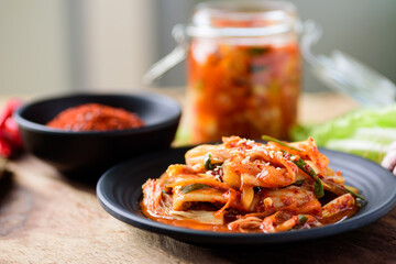 Kimchi cabbage with ingredients on wooden table, Korean food