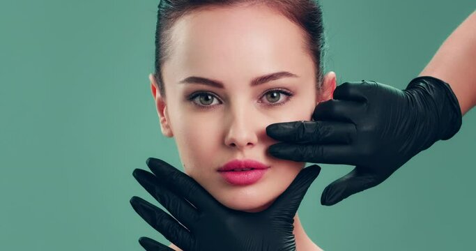 Slow motion clip - Doctor checks a skin before plastic surgery.  Face skin check before plastic surgery. Beautician touching woman face. Plastic surgery. Doctor is touching face of a patient by hands
