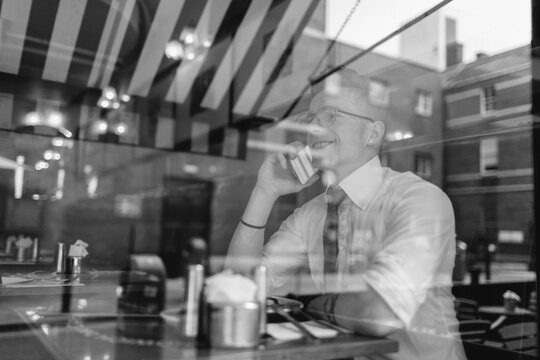 Businessman on the Phone Through a Coffee Shop Window