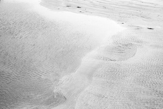 Sea water meets the sandy seashore