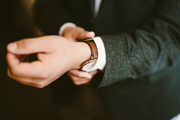 Man's hand fastening watch