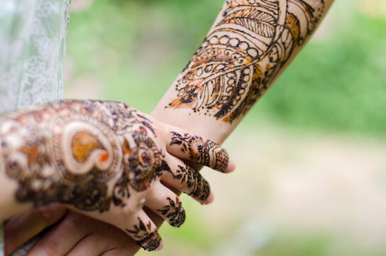A woman with henna adorned arms and hands !