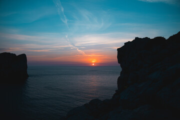 Beautiful and scenic sunset on the rocks in the famous lokking point of CAPO CACCIA, in Sardinia,...