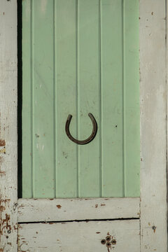 Good lUck Horseshoe on rustic green barn door