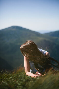 Young woman on top of mountain