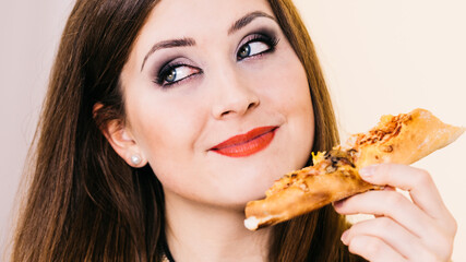 Woman eating hot pizza slice