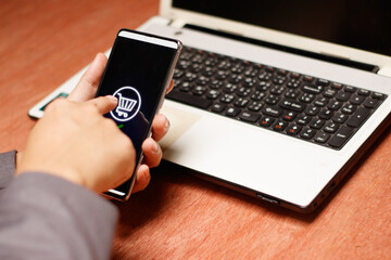 Hands holding credit card and using laptop. Online shopping
