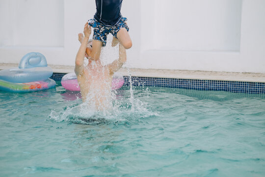 Dad launches his son in the air from the swimming pool
