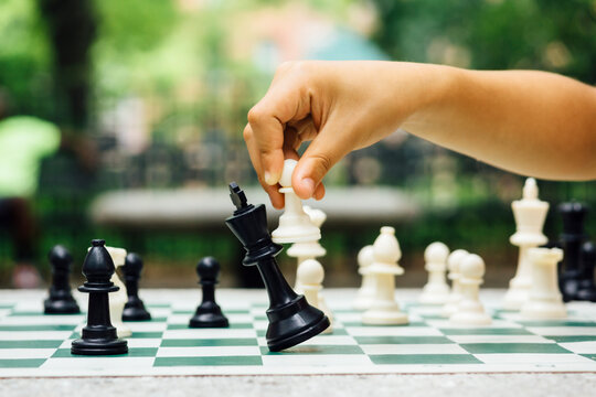 Checkmate - pawn in child's hand checkmates king