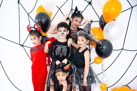 Group Of Asian Children In Halloween Costume With Make Up In Halloween Party At Home.