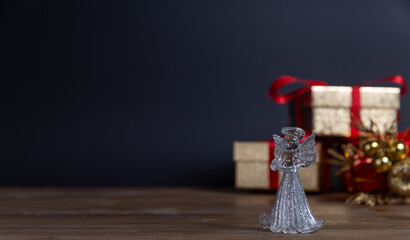 little glass angel. Christmas and New Year decoration on a dark background. holiday banner