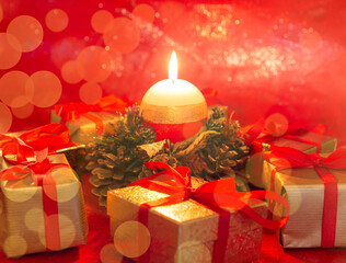 Christmas candle with gifts on a red background. Festive banner. Christmas and New Year background