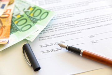 Closeup of contract and money.