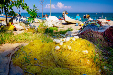 Heap of commercial fishing net on the sandy beach