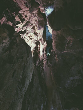Looking up into a natural rock shaft in a cave