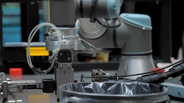 Industrial robot at work in the factory of plastic products.