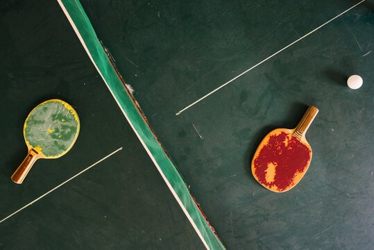 Pair of run down ping pong racketes from above