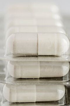 Closeup of white capsules in blister pack