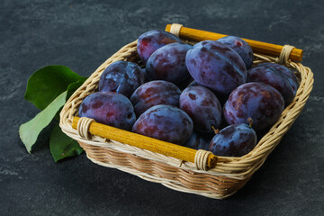 Ripe plum heap in the basket