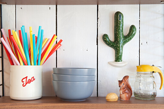 Shelves in a kitchen with fun retro items, bowls and canisters