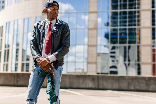 Portait of a man wearing street dapper ontop of a rooftop