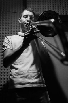 Ska/punk musician playing trombone on rehearsal om studio.