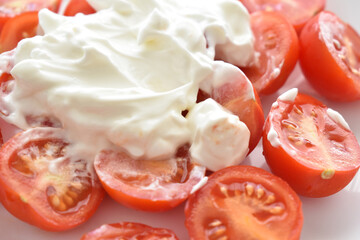 Cherry tomato salad with Greek yogurt.  Copy space is on the left side. 
