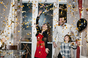 Family dancing together while confetti is thrown