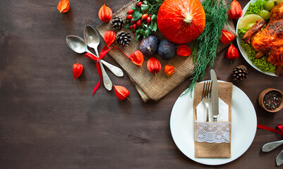 Festive table setting with pumpkin, autumn leaves and seasonal autumn decor. Autumn style table setting .Copy space.