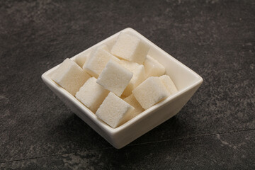 Refined white sugar cubs in the bowl
